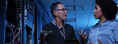 A server technician and an engineer discussing memory upgrades in a server room