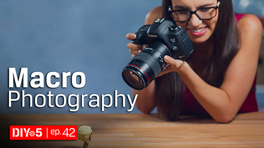 Trisha using a DSLR camera to photograph a small figurine.